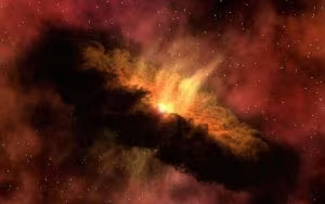 Nebulosa vermellosa i ataronjada a l'espai estelat