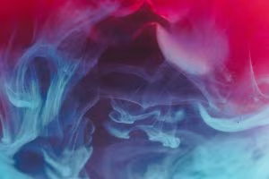 Swirls of blue and pink smoke on a purple background