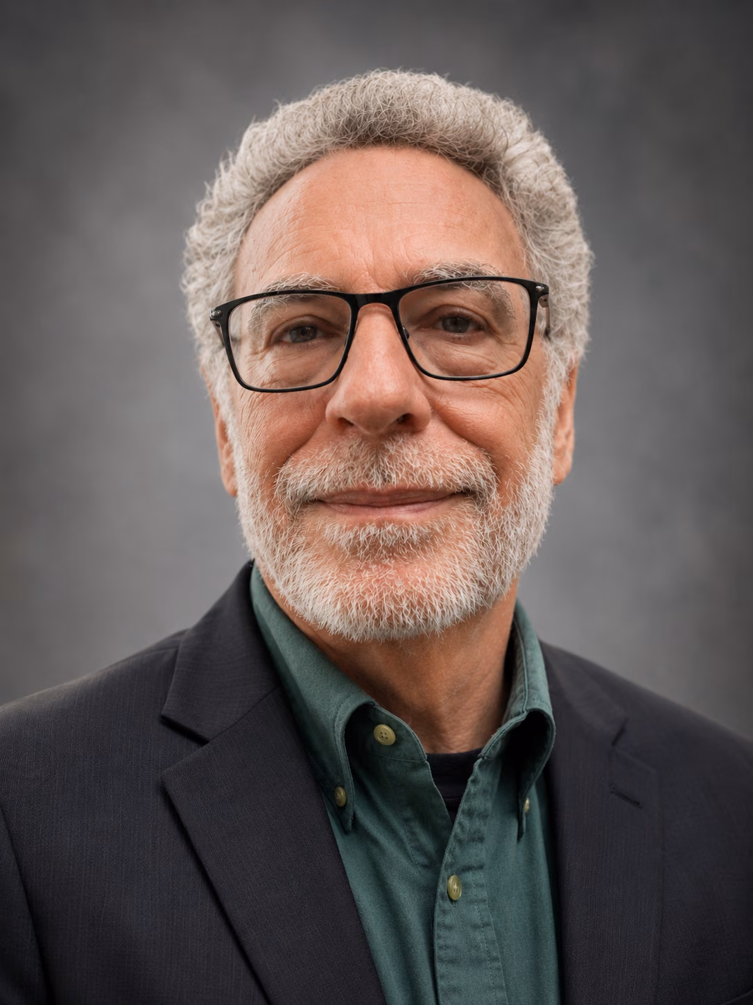 Mark Cornfield wearing glasses and a dark blazer